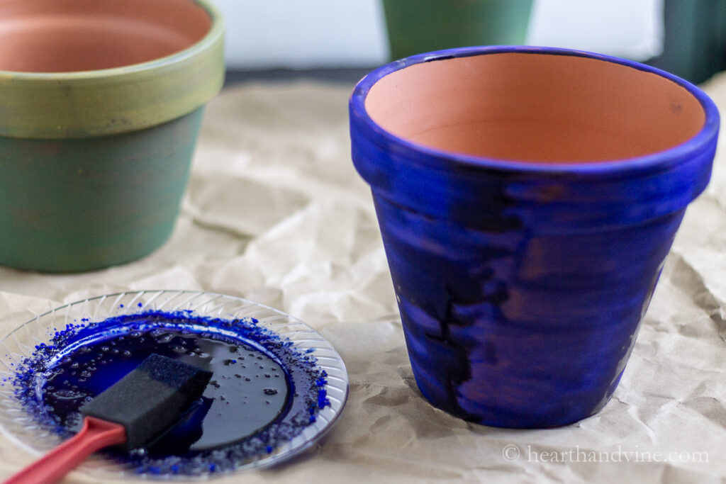 Clay pot freshly painted with cobalt pigment and linseed oil.