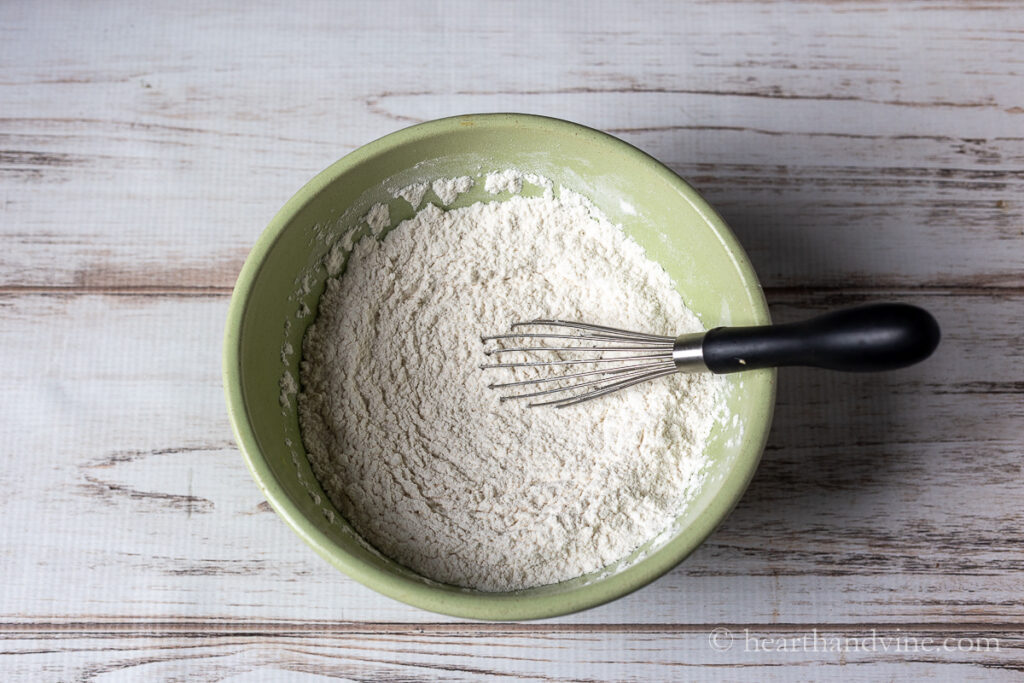 Bowl of flour, salt and baking powder mixed with a whisk