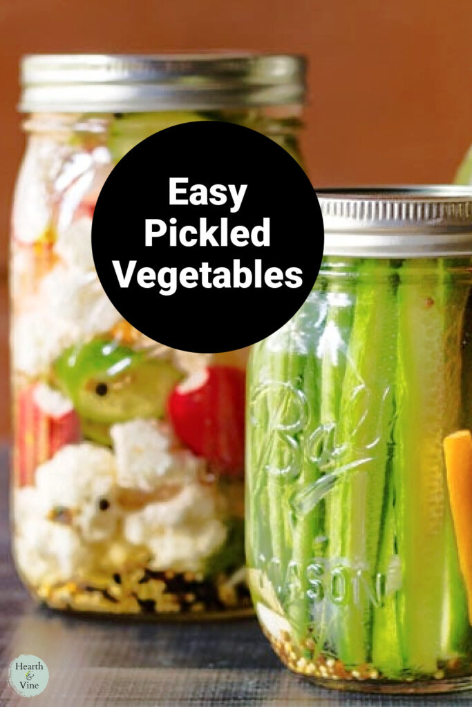 Two mason jars with vegetables and pickling liquid. One pint sized with cucumbers and one quart with radishes, cauliflower and green beans.