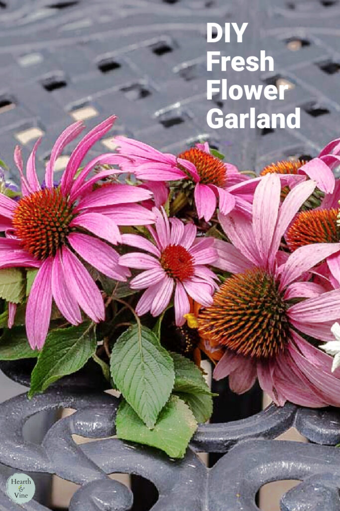 Purple coneflowers in the center of a table as part of a garland.