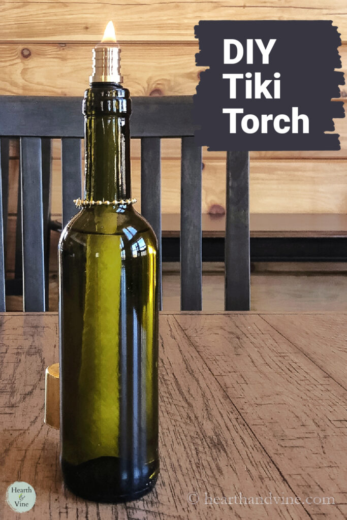 Green wine bottle tiki torch on a table.