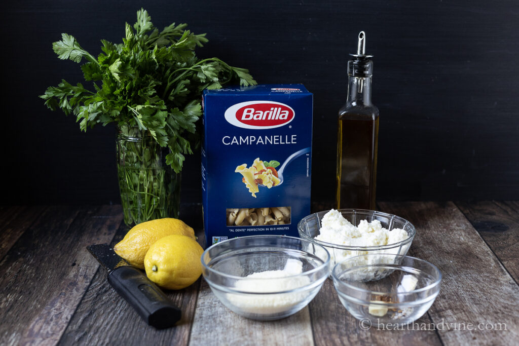Italian flat-leaf parsley, box of campanelle pasta, lemons, Parmesan cheese, ricotta cheese, olive oil and spices.