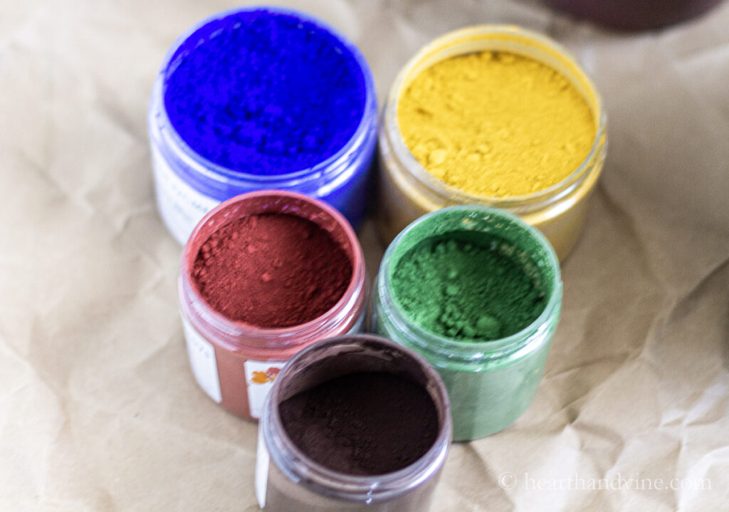 Jars of natural pigment powder.