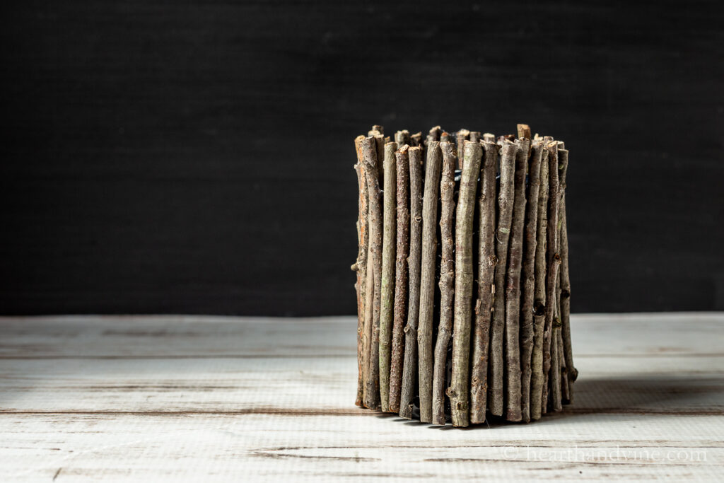 Rustic twig vase on a table.