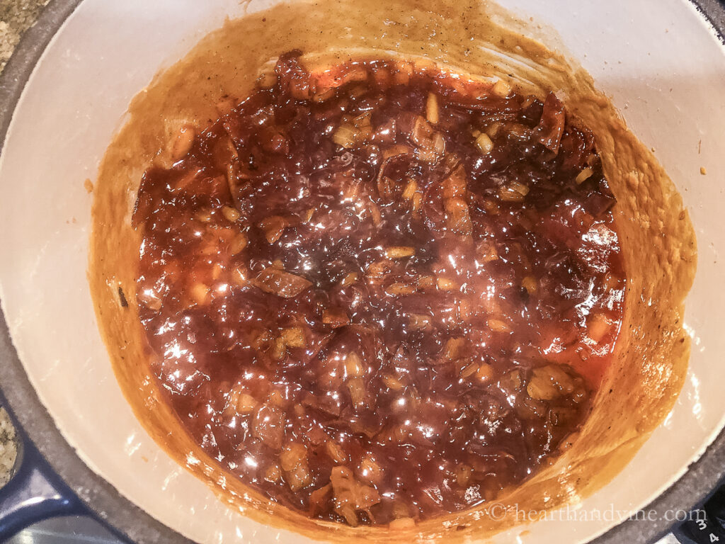 Baked beans sauce in the bottom of a Dutch oven pot.