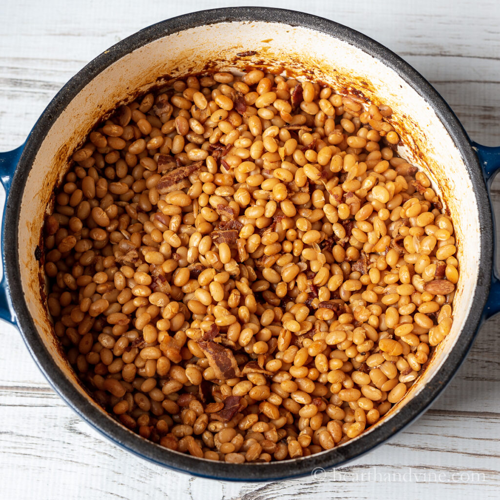 Large Dutch oven filled with homemade baked beans.