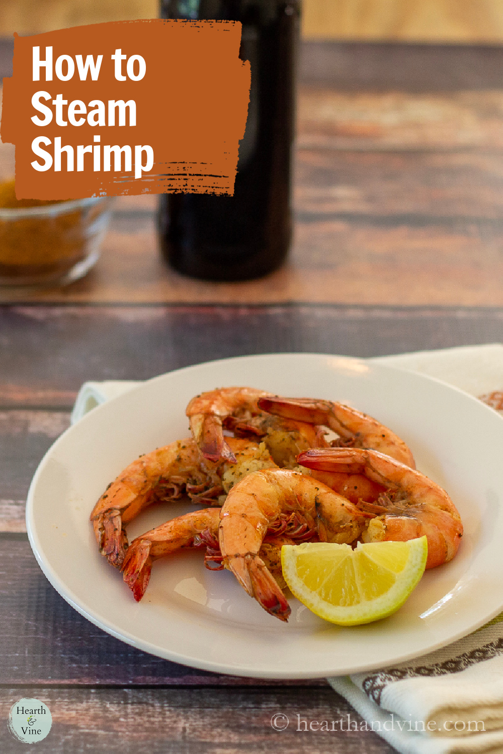 Plate with a lemon wedge and steamed shrimp