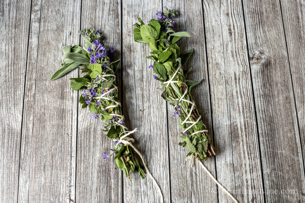 Bunches of herbs and flower tied together with cotton string.