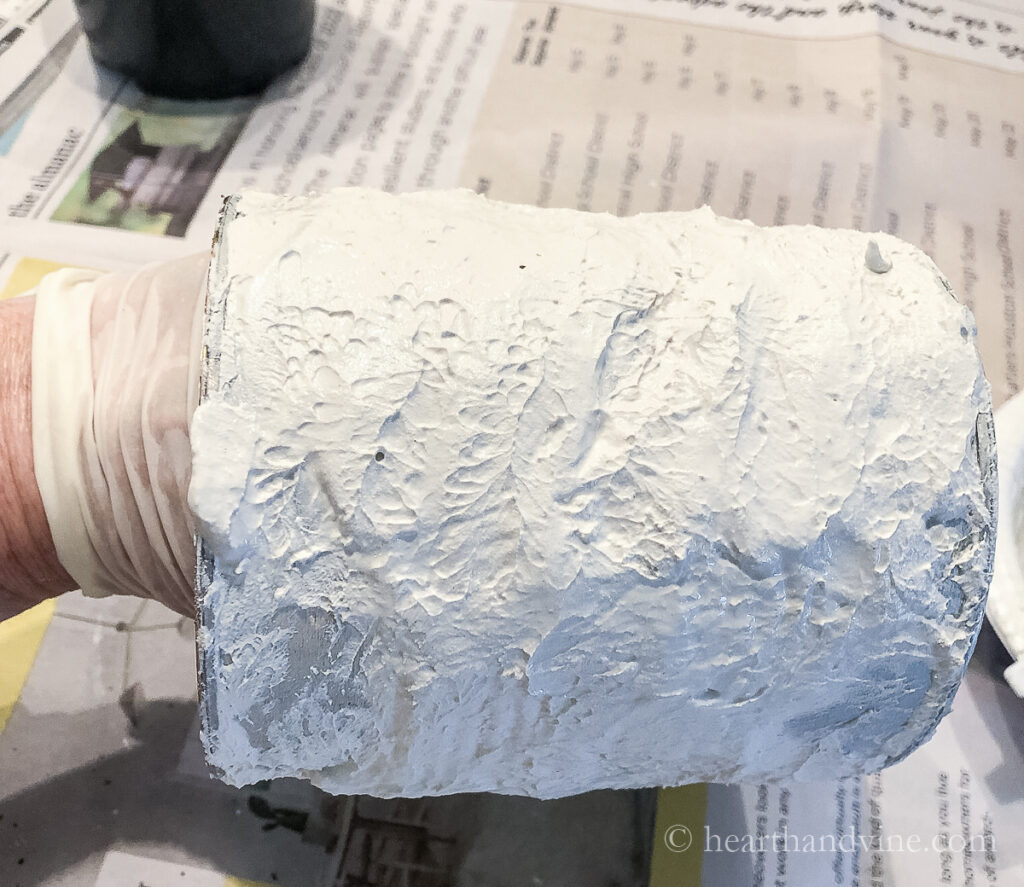 Thick plaster of Paris layered on to a tin can.