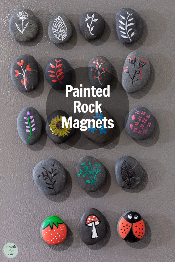 Group of hand painted rocks with magnets on the back on a refrigerator.