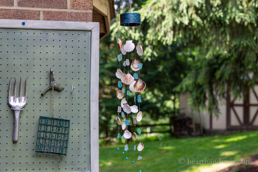 Wind chimes made from seashells and sea glass hanging on the patio.