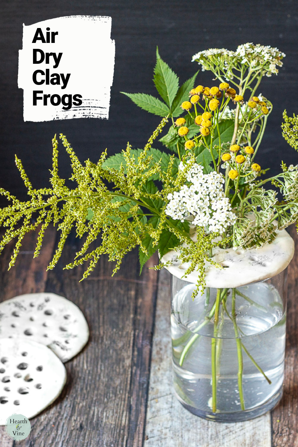 Green and yellow flower arrangement using clay flower frogs and a couple of clay frogs on the side.