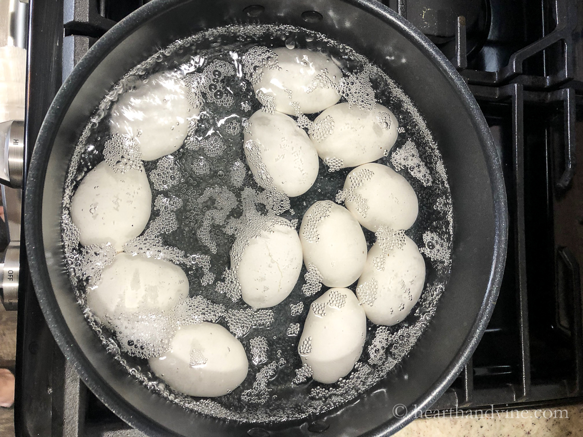 Eggs boiling in a pot of water.