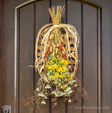 Fall flowers and tobacco basket on a brown door.