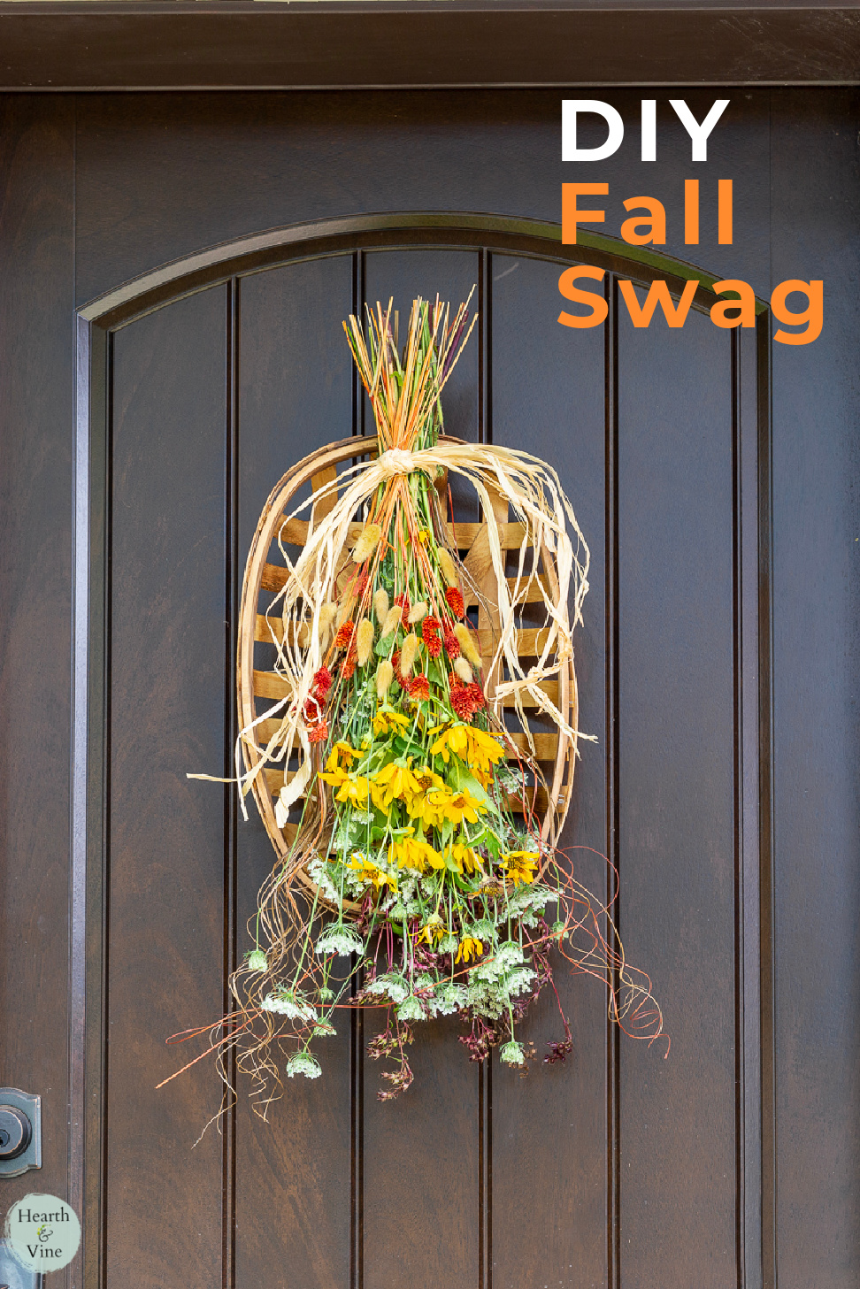 Fall swag tied to a tobacco basket hanging on the front door.