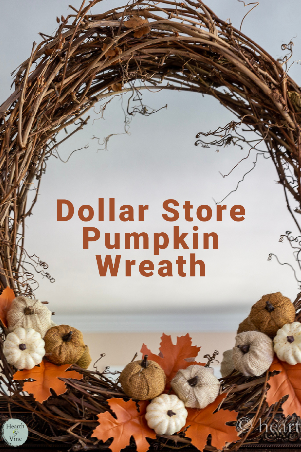 Grapevine base wreath with faux pumpkins and autumn leaves.