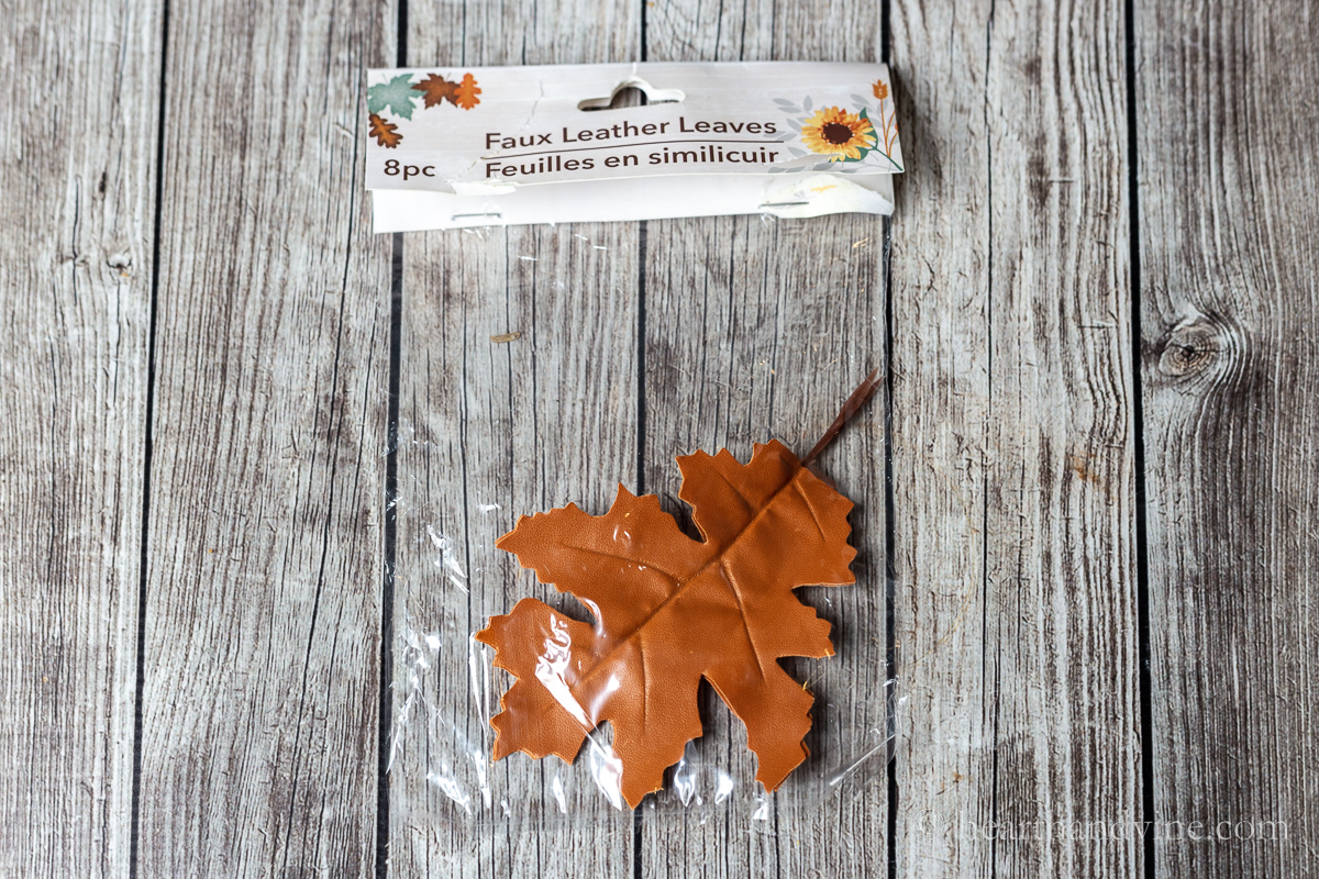 Mini pumpkins and faux leather oak leaves.