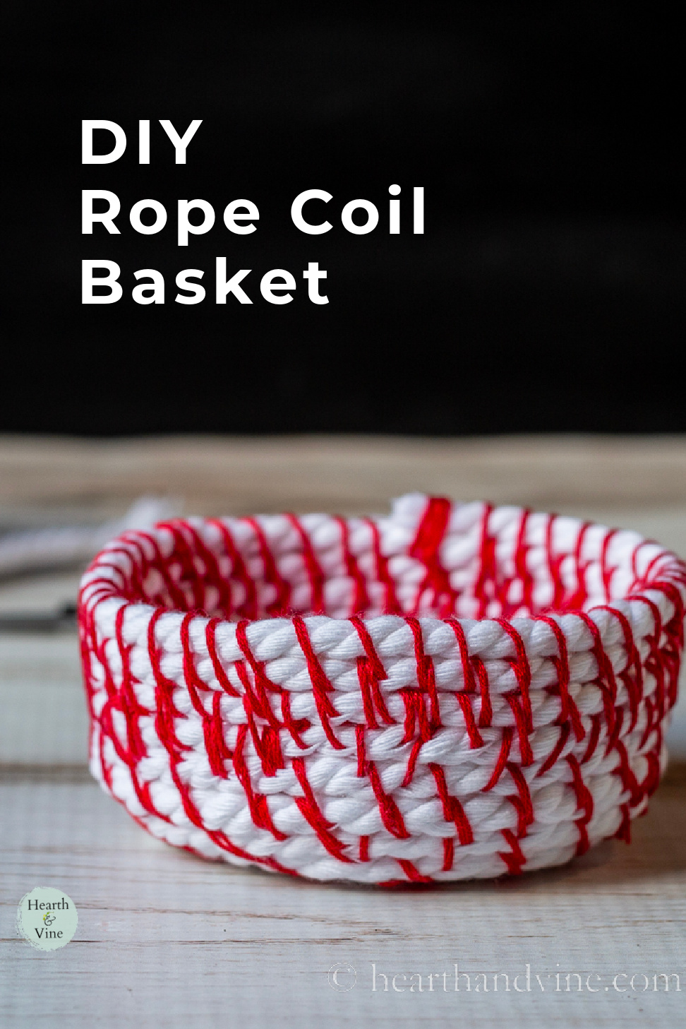 Small coil basket with red stitches.