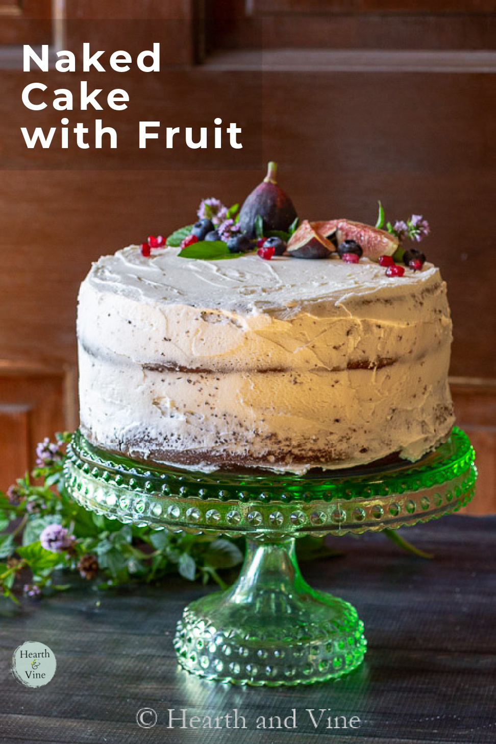Chocolate naked cake topped with fresh figs, pomegranate seed, mint leaves and mint flowers.