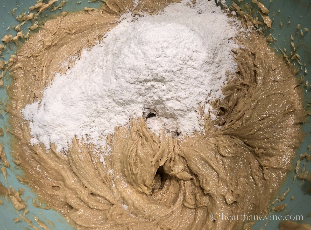 Adding dry flour ingredients to wet sugar, butter and egg mixture.