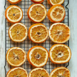 A baking rack filled with dried orange slices.