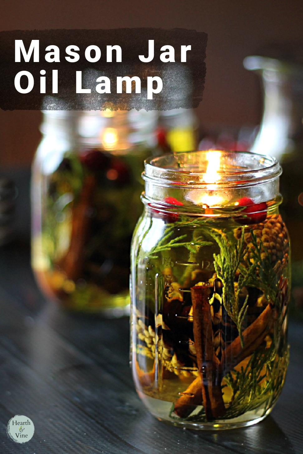 A mason jar filled with cedar, pine cones, cinnamon sticks cranberries, orange slices with a floating wick.