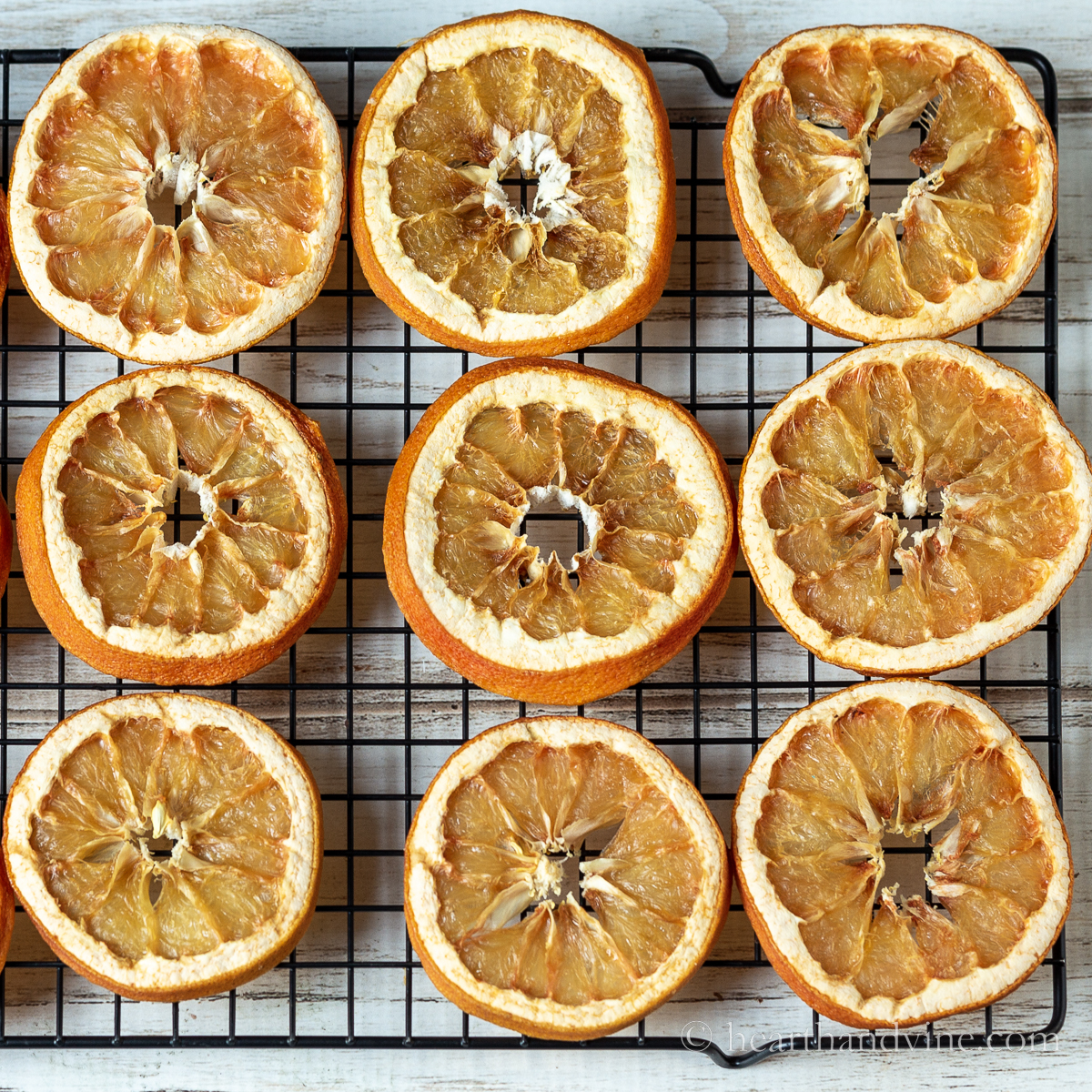 Dried orange slices on a baking rack.