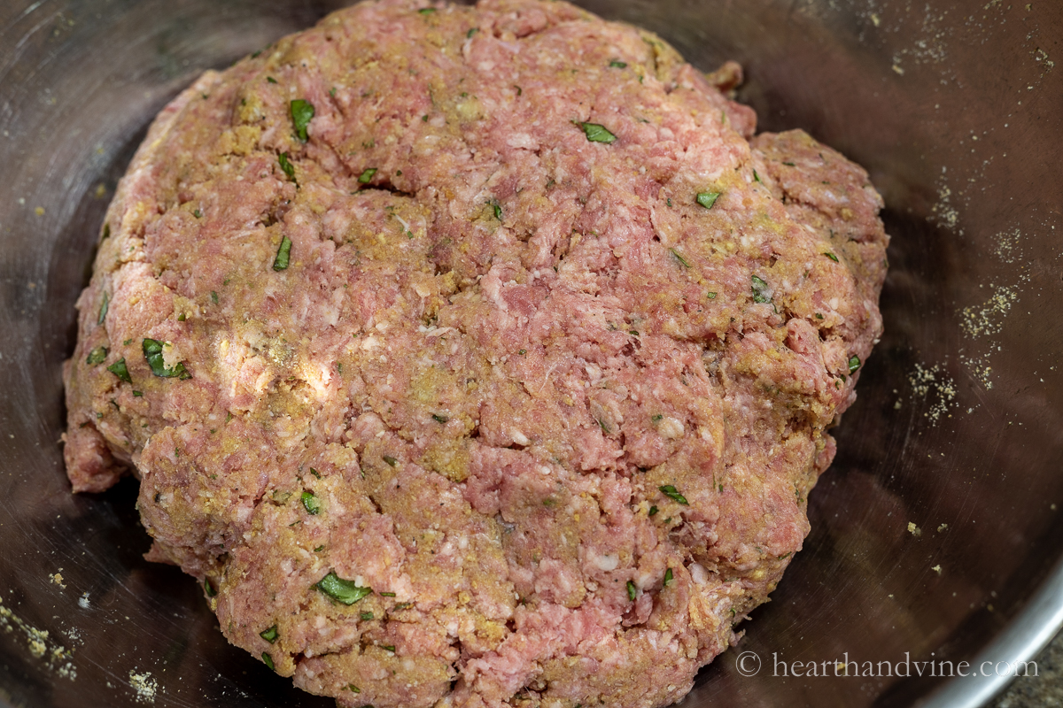 Italian meatball mixture in a large mixing bowl.