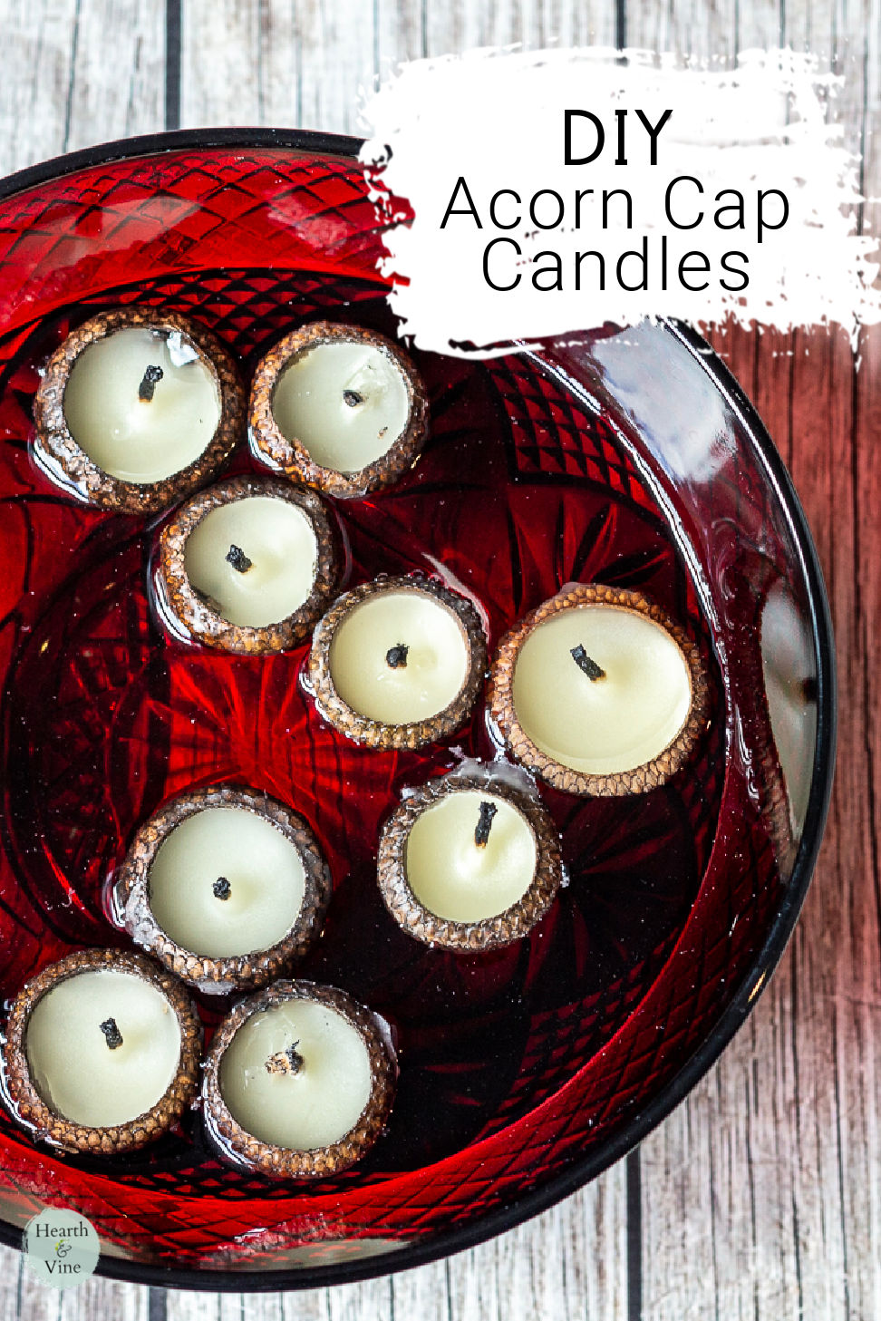 Acorn cap candles floating in a red bowl of water.