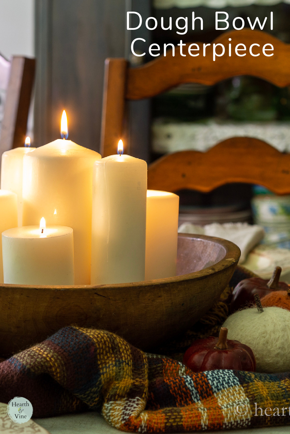 Pillar candles lit in a round dough bowl centerpiece.