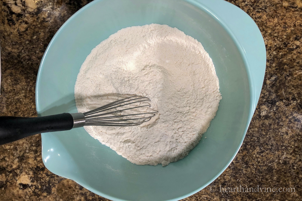 Flour, salt, and baking powder whisked together in a mixing bowl.