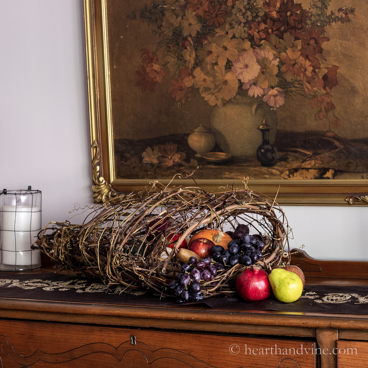 Grapevine cornucopia with fruit and pumpkins.