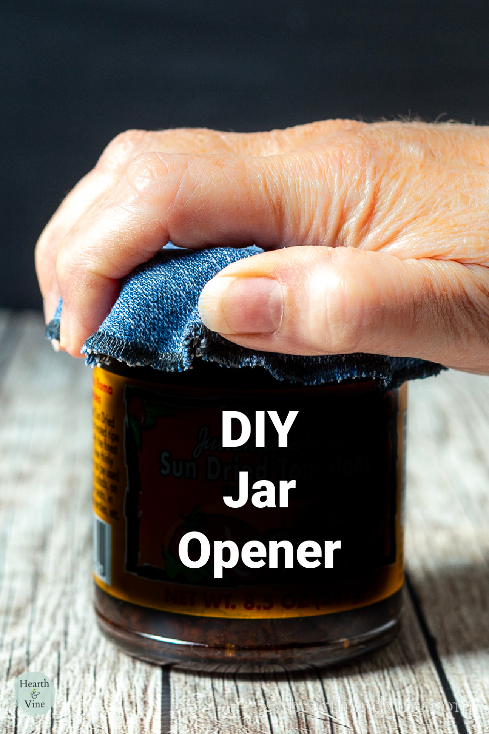 Hand using a rubber jar opener on a small jar.