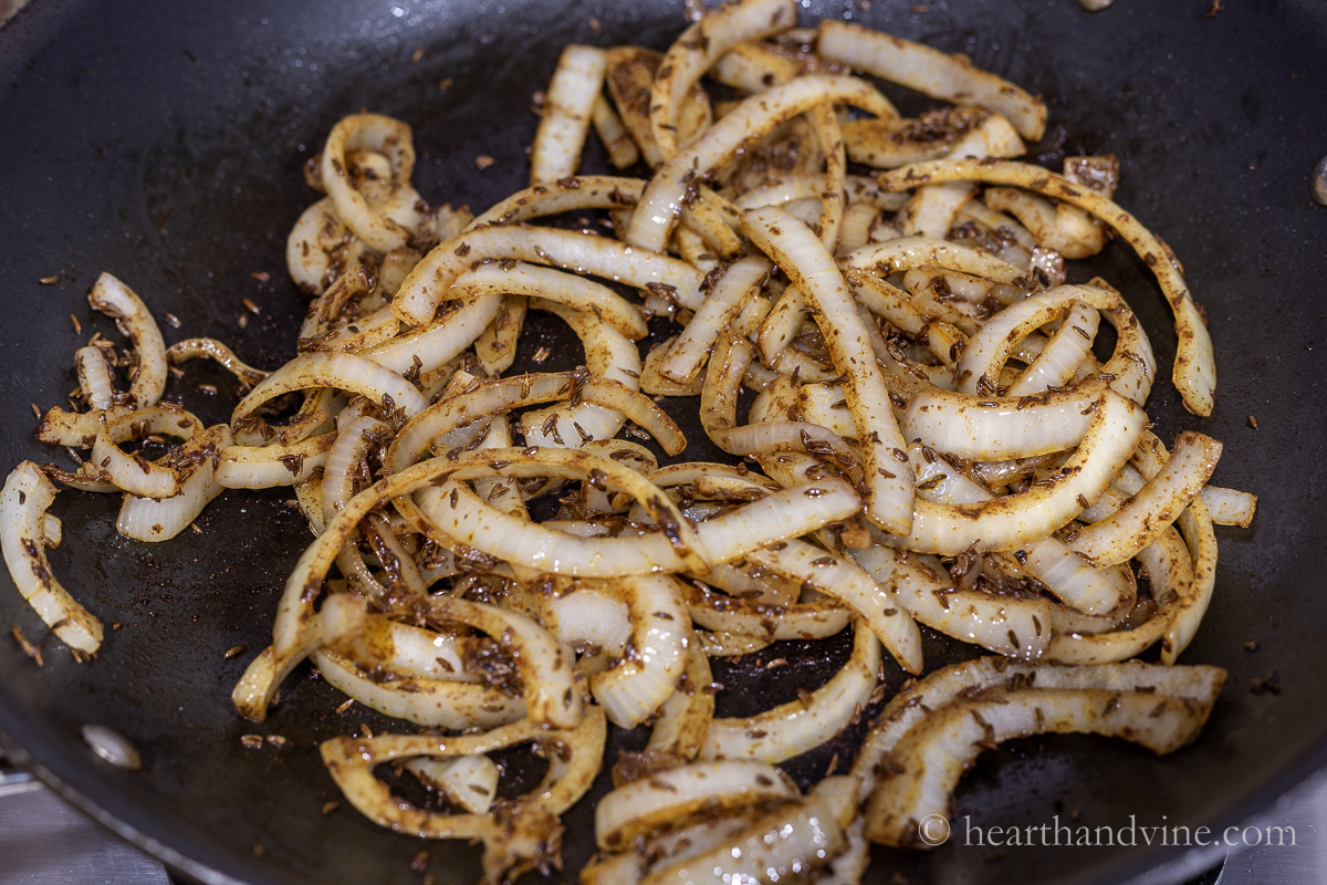 Slices onions sautéed in a large pan with caraway seeds, cinnamon, paprika, salt and pepper.