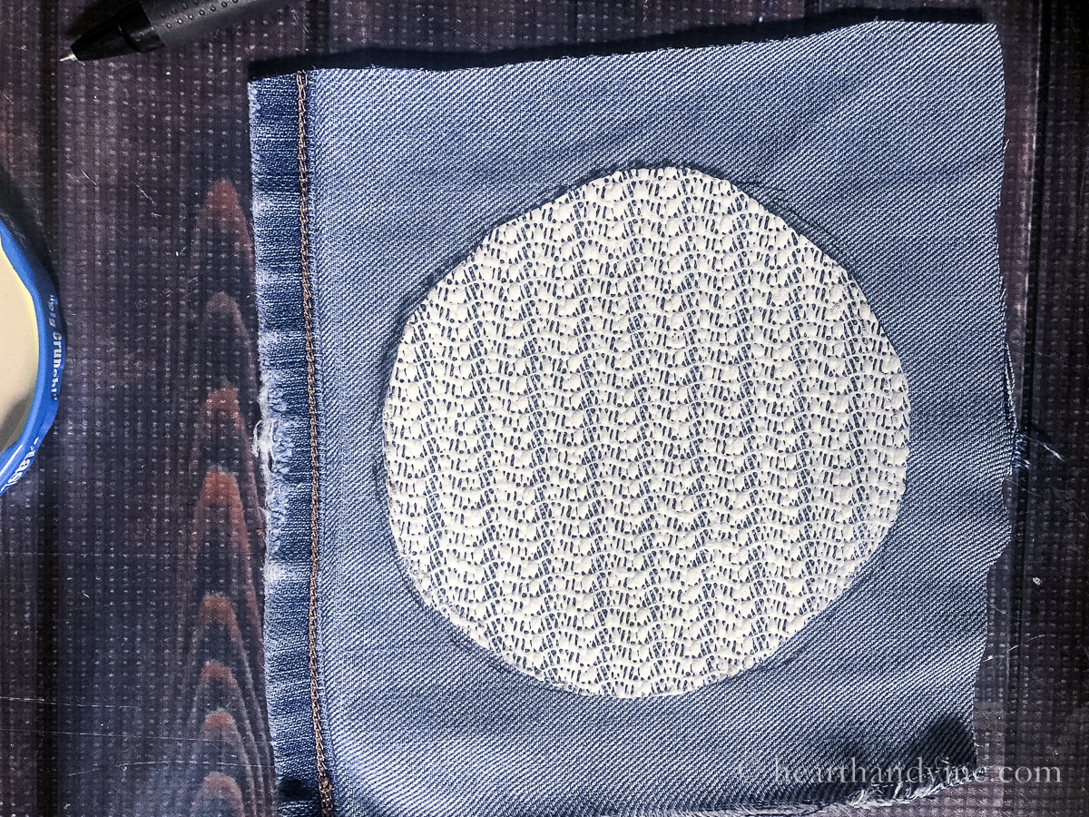 Rubber circle traced to jeans fabric.