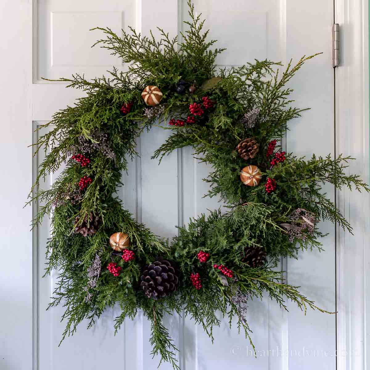 Evergreen wreath on a white door.