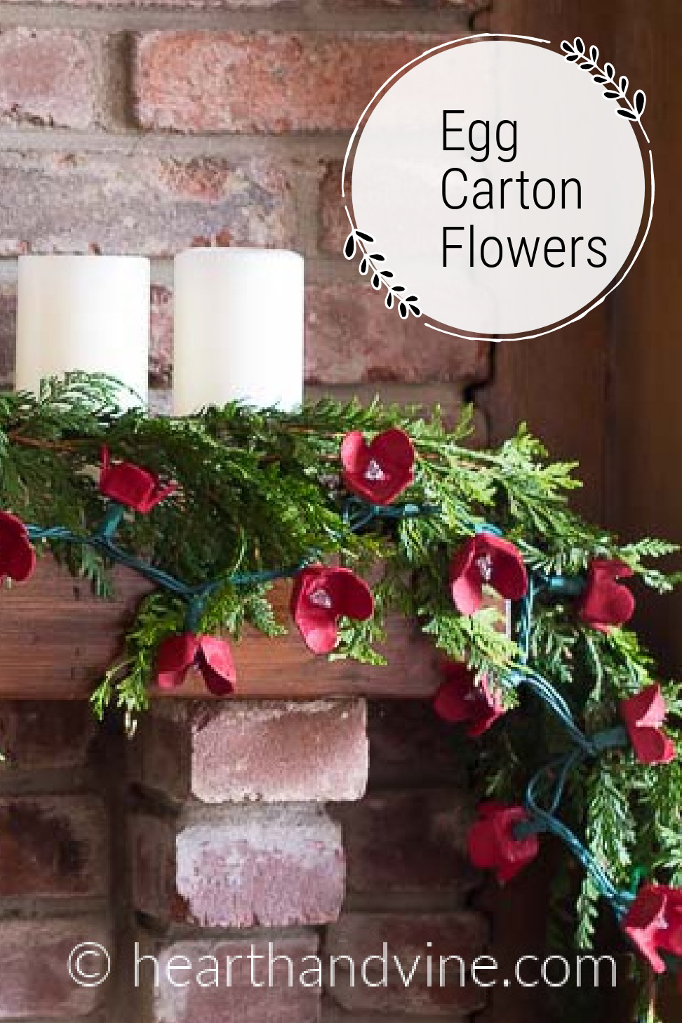 Egg carton flowers painted red and placed on lightbulbs from a string of lights as a garland for a mantel.