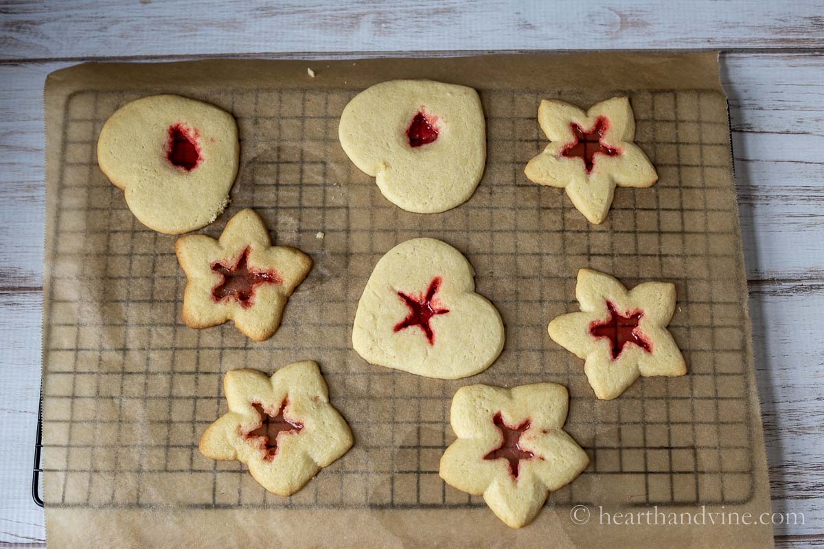 Stars and hearts cookies on a cooling rack.