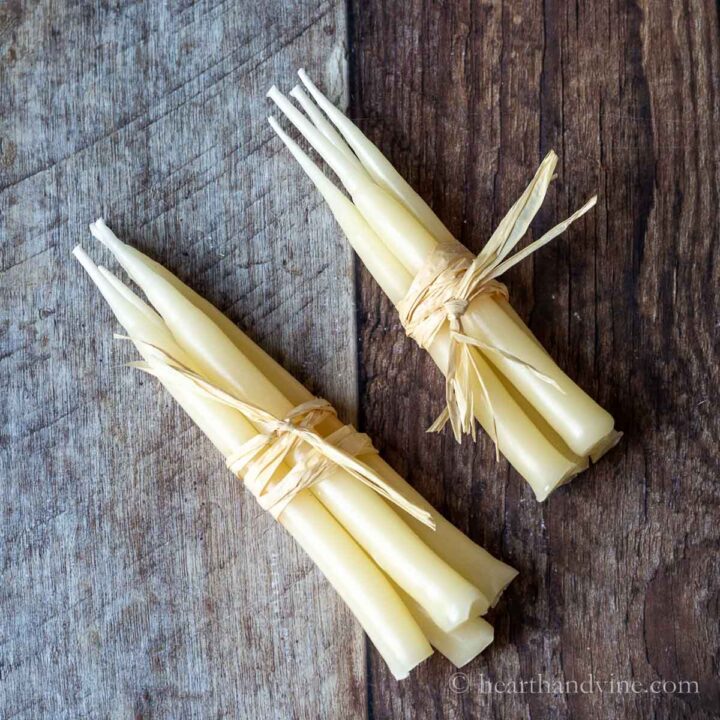 Two bundles of hand dipped beeswax taper candles.