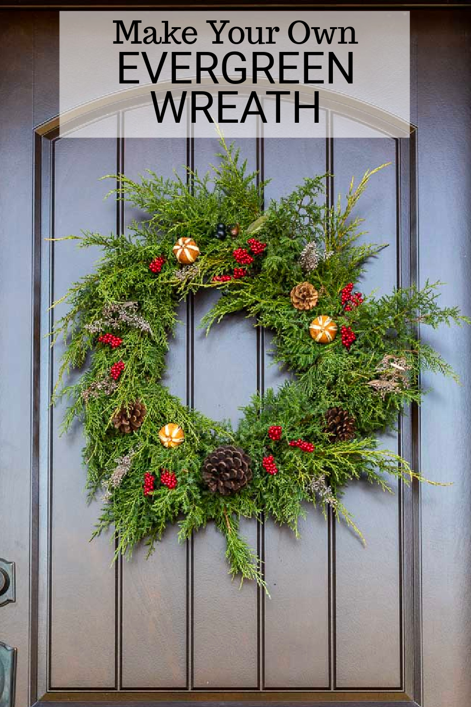 A fresh evergreen wreath adorned with dried citrus, faux berries and pinecones.