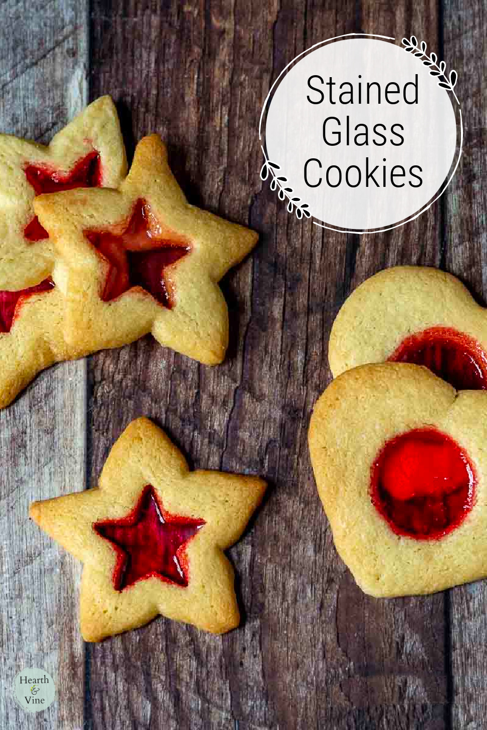 Stars and hearts stained glass cookies on a table.