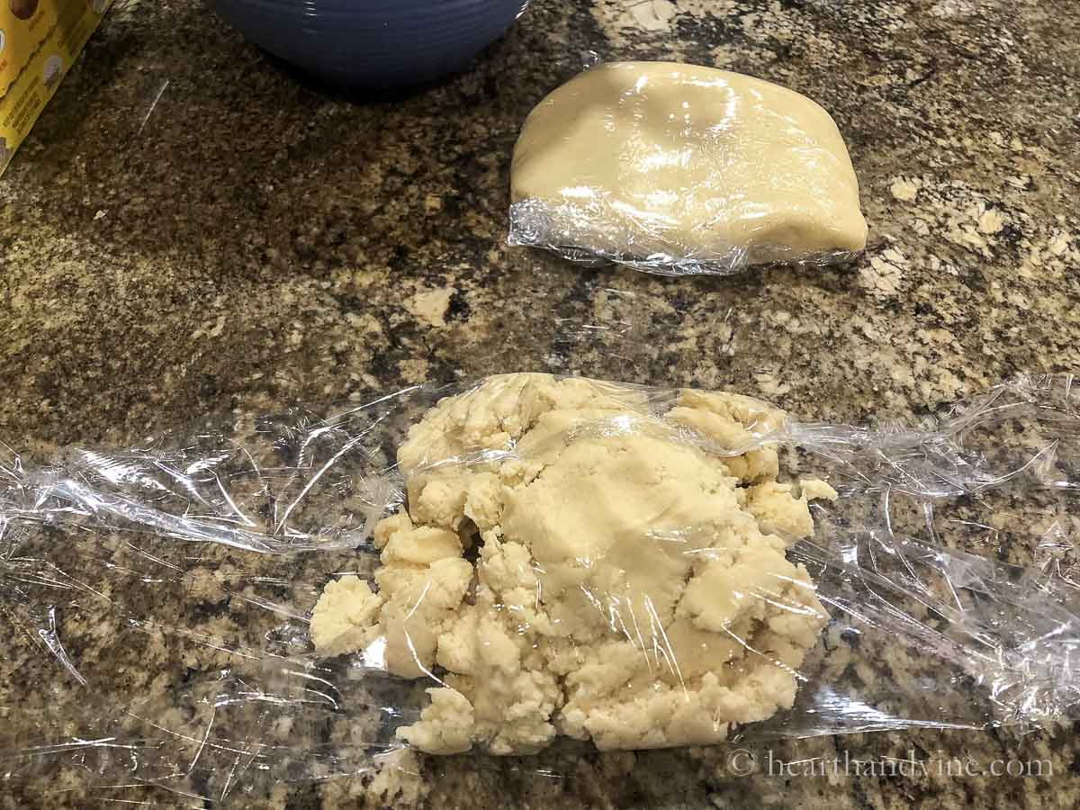 Wrapping cookie dough with plastic wrap.