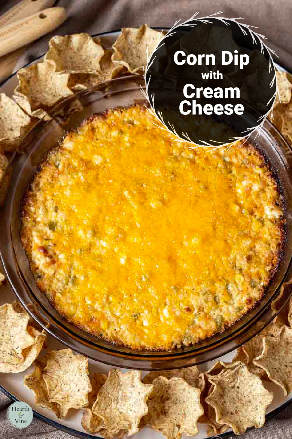 A pie plate with baked corn dip and chips around the edges.