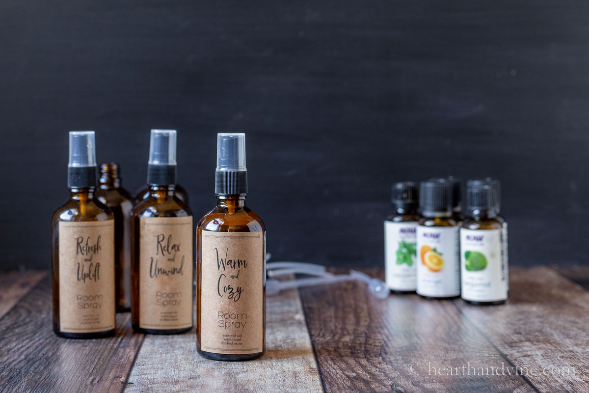 DIY room spray bottles next to several essential oil bottles.