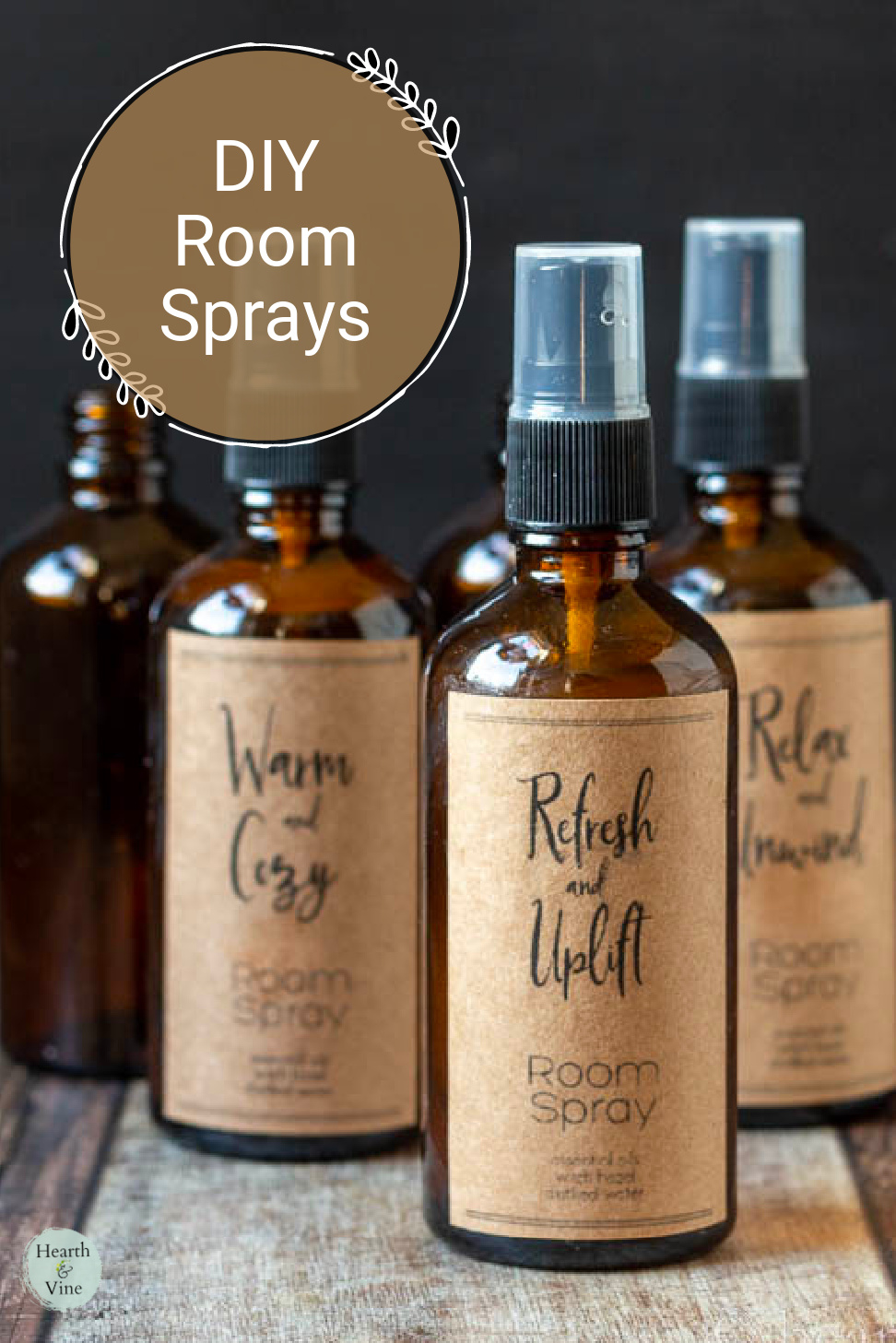 Amber glass spray bottles with brown kraft paper labels for holding essential oil room sprays.