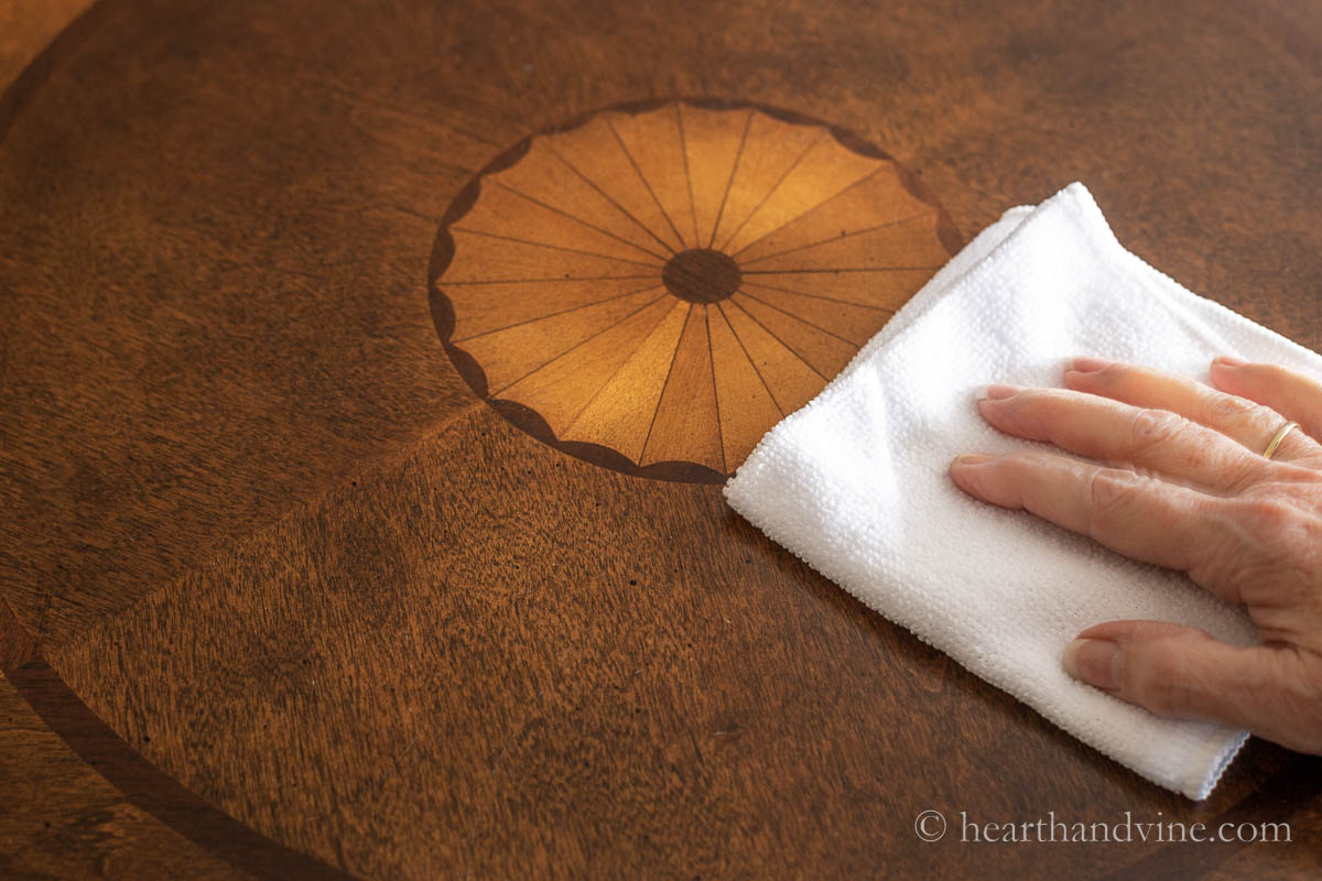 A white dust cloth on a wooden table.