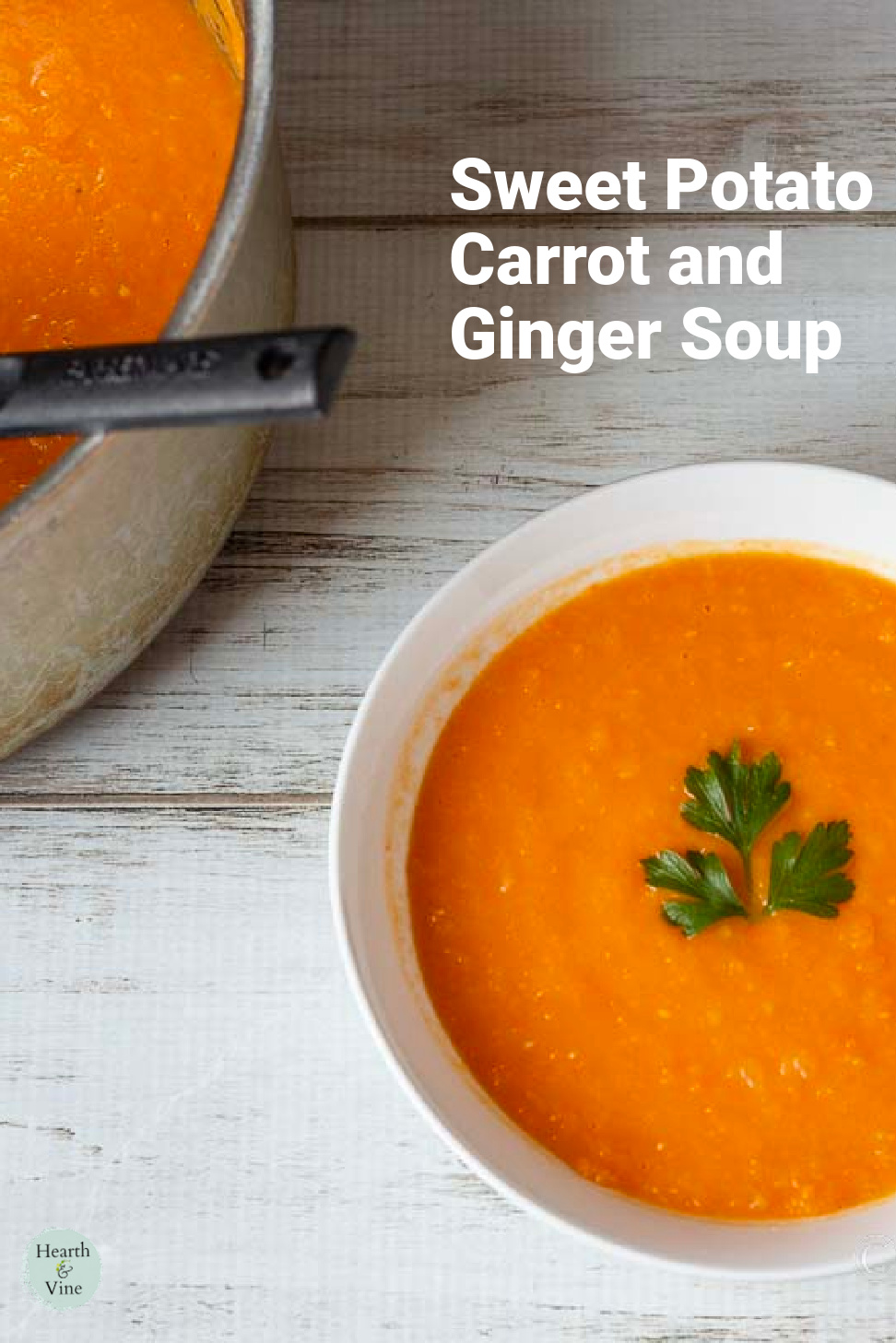 Bowl of sweet potato carrot soup next to a pot of the same soup.