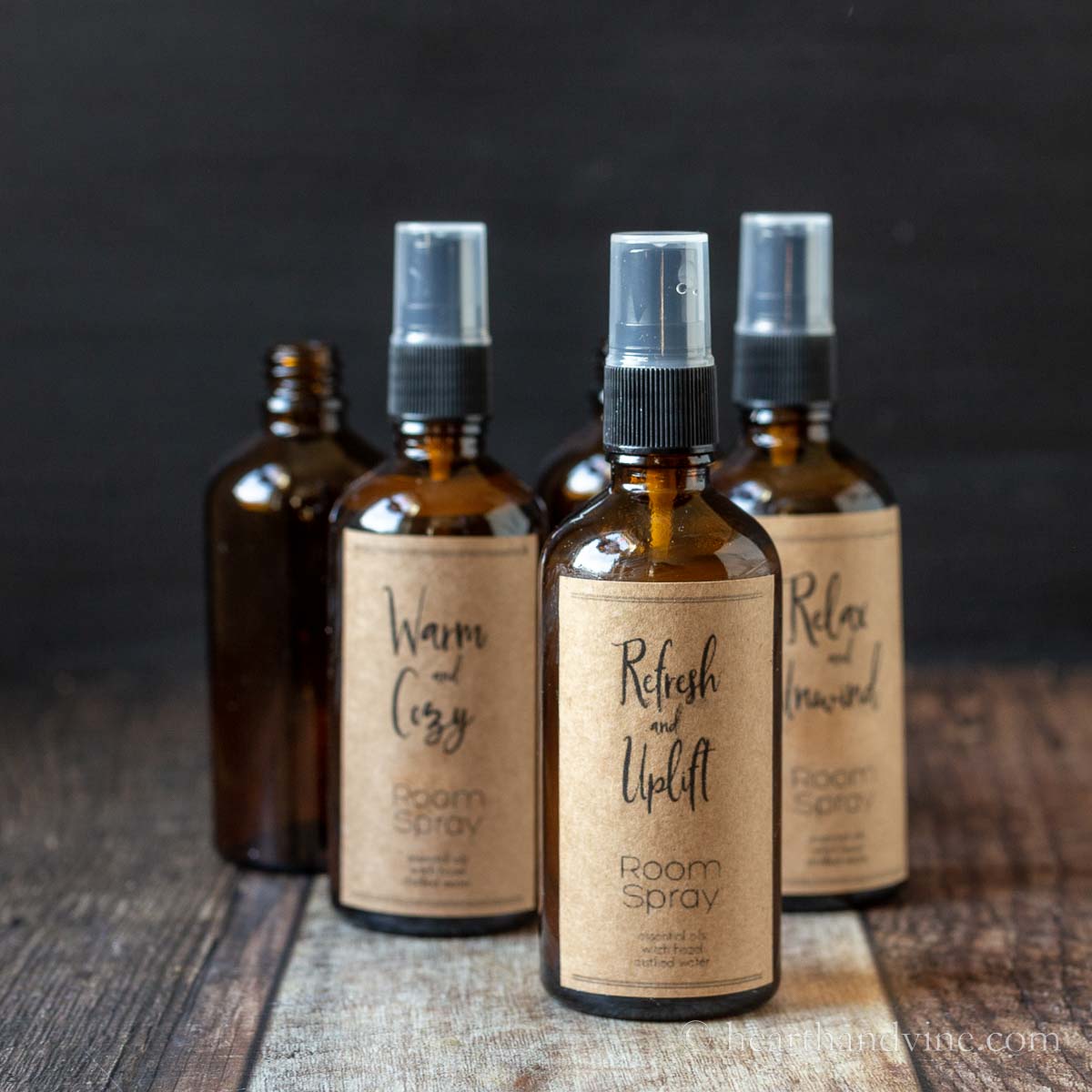 Amber room spray bottle with brown kraft paper labels.