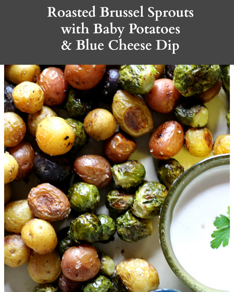 Roasted brussel sprouts and baby potatoes with a bowl of blue cheese dip.