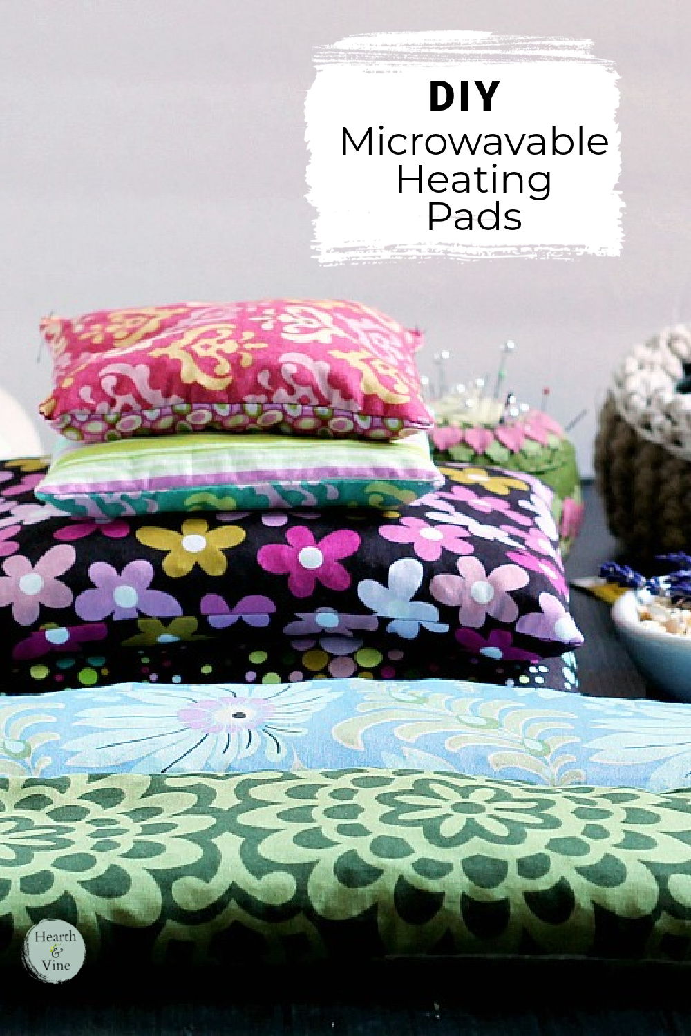 Stack of different colored are patterned fabric corn filled heating pads.